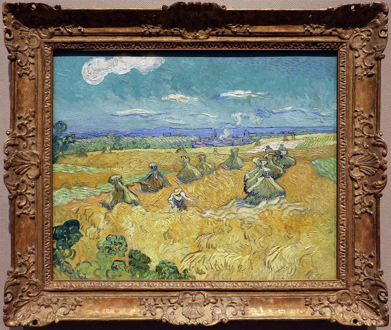 Pole pszenicy z snopkami i żniwiarką - Vincent van Gogh