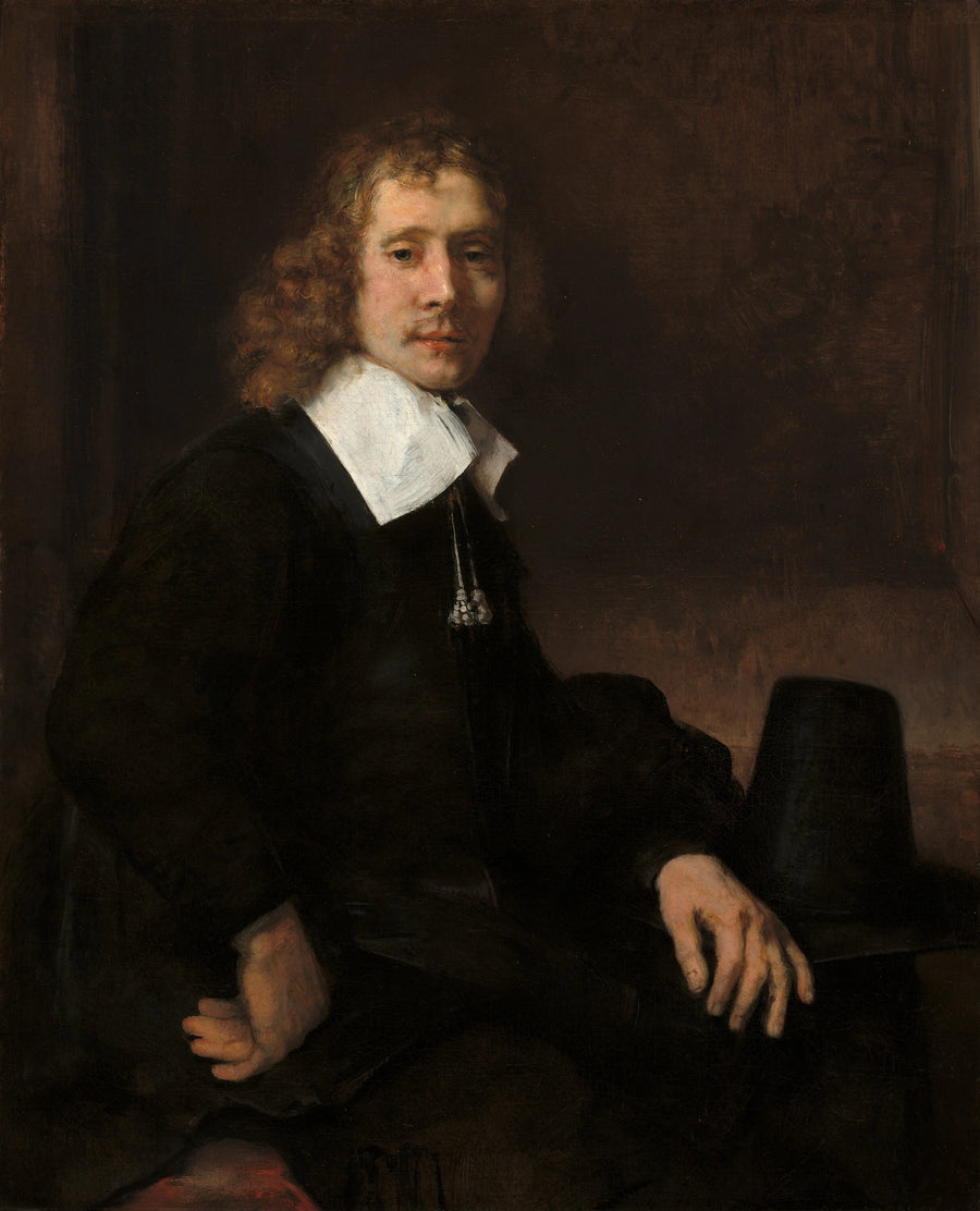 Młody mężczyzna siedzący przy stole (może Govaert Flinck) - Rembrandt